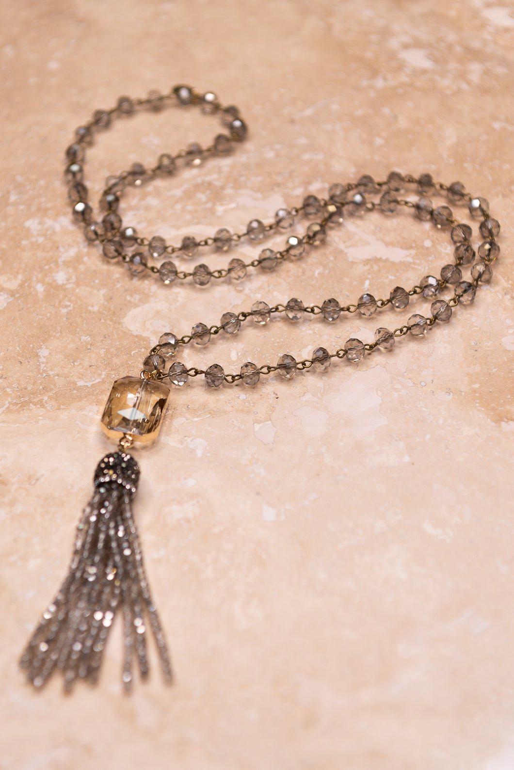 Long Crystal Bead Strand Necklace Holding A crystal And Beaded Tassel